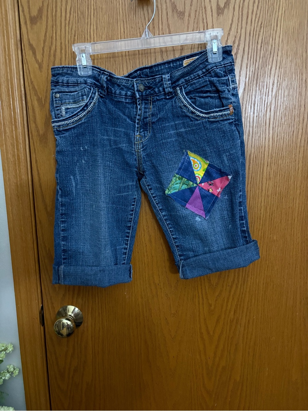 Y2K Toxic size 9 he’s cut-off cuffed shorts with pinwheel patch